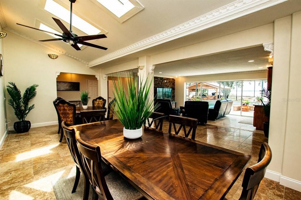 Formal and informal dining open to the living area with amazing views of pool and lake!