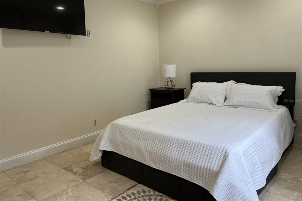 Downstairs Bedroom 2 with Queen Bed, 55" TCL Smart TV, views to pool & lake!