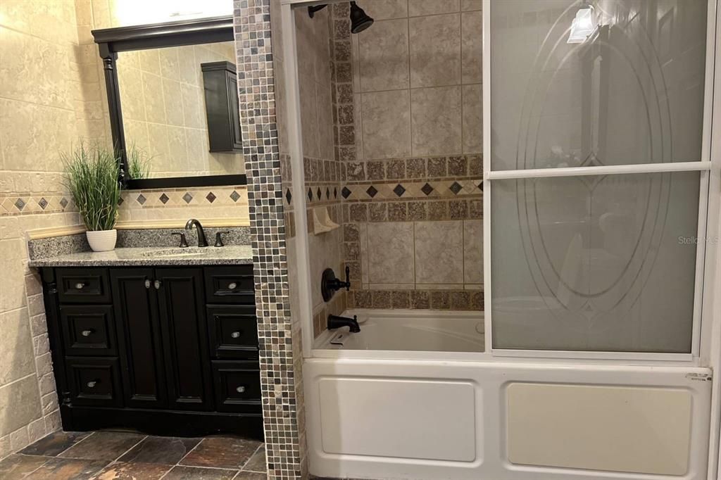 Shared downstairs bathroom with tub & shower combination & two separate vanities!