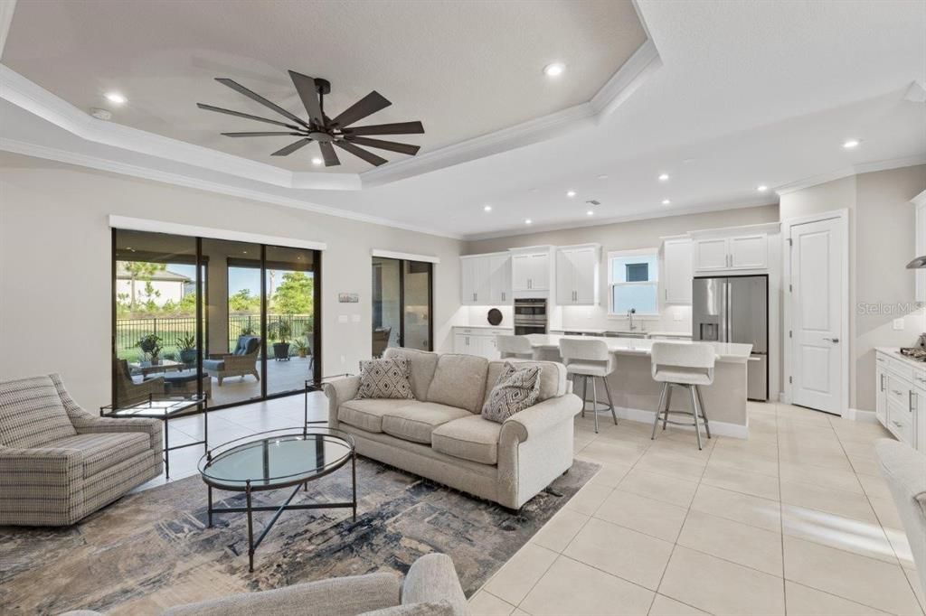 Living Room with 11' tray ceilings, and dual sliding glass doors.