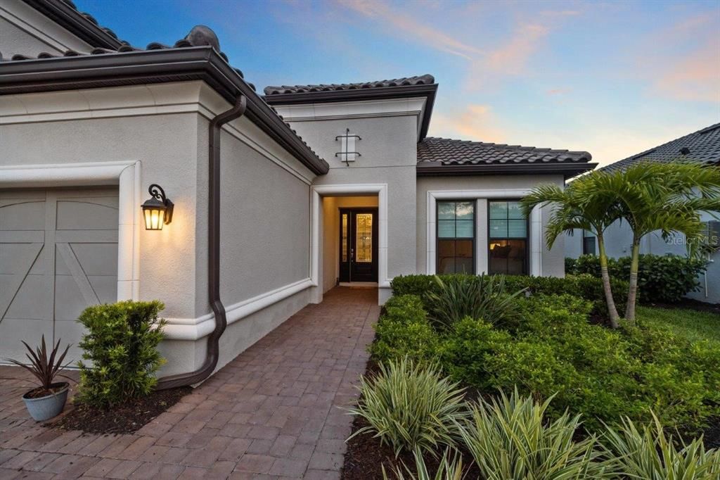 Front entryway with a designer 8' front door and sidelite windows.