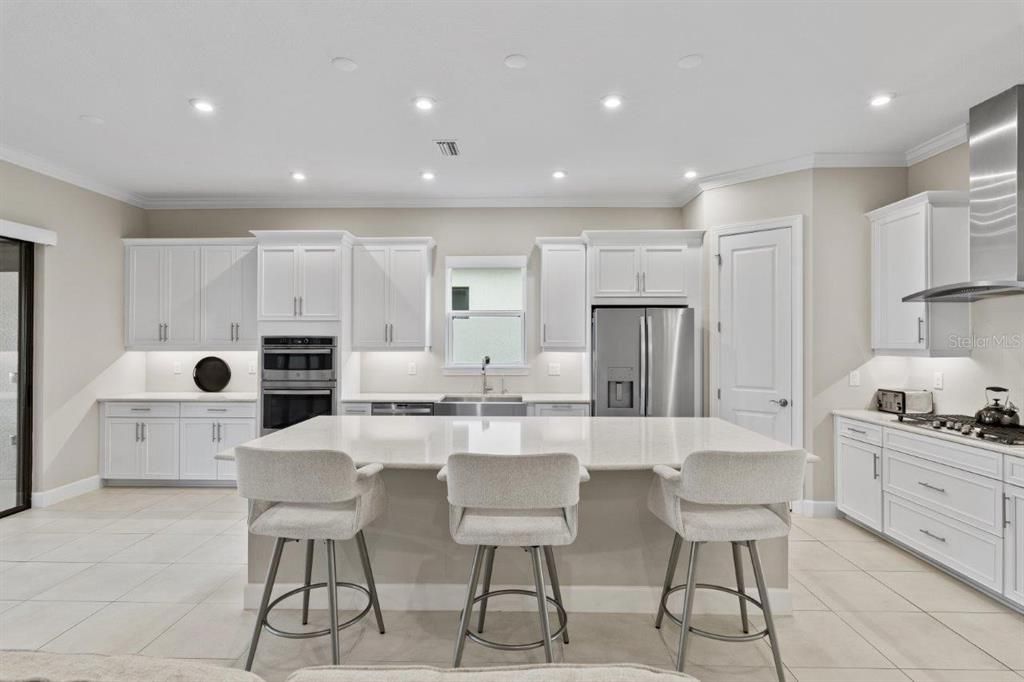 Extended Gourmet Kitchen featuring upgraded GE Profile appliances, and 42" wood cabinetry