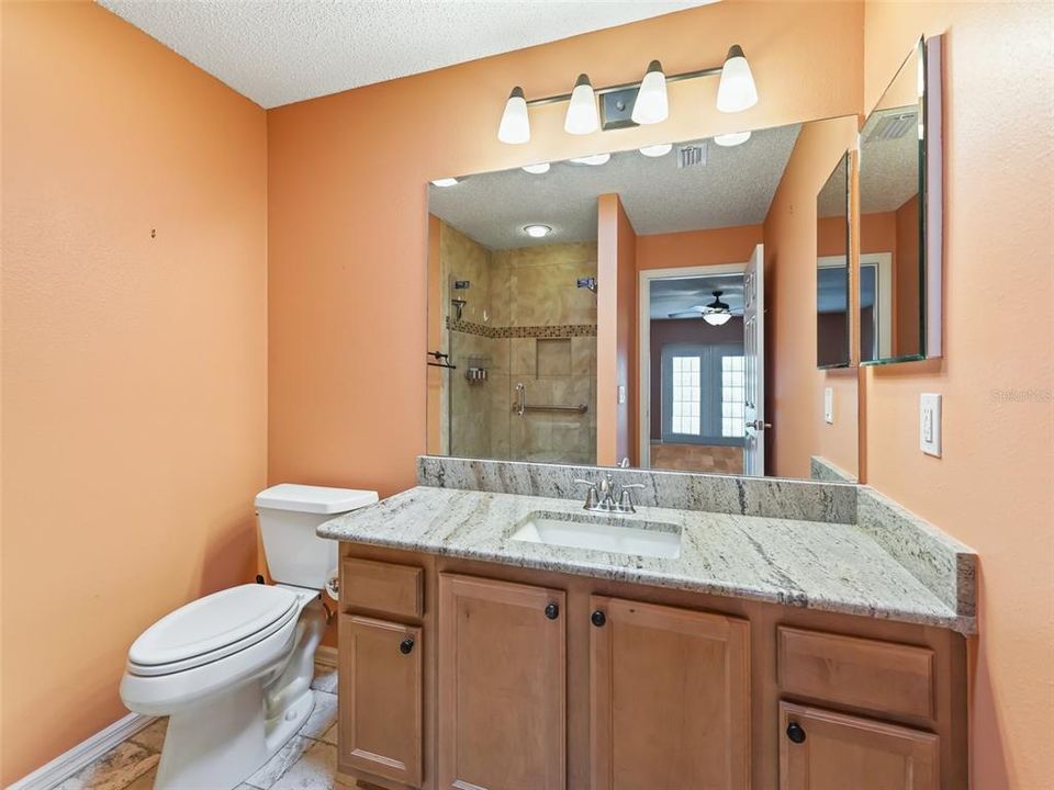 Master Bath with Granite Counters and a Lovely Walk In Tiled Shower with Glass Doors