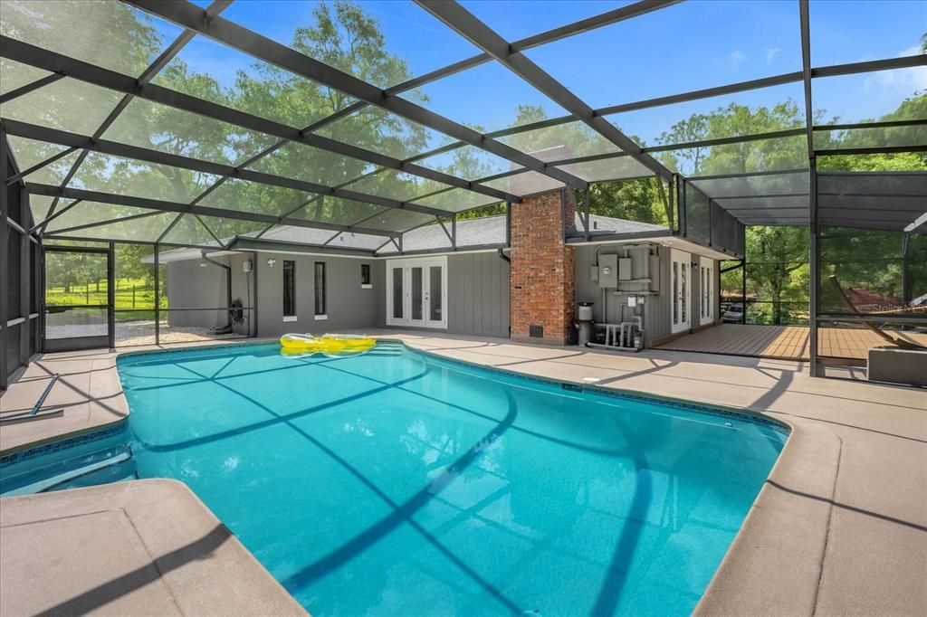 Expansive Pool area Connects with the Large Porch that Leads from the Dining and Kitchen Area