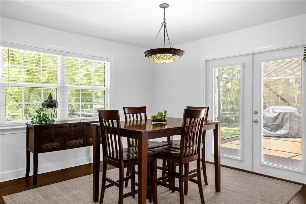 Dining area Adjacent to Kitchen and Family Room with French Doors to the Screened Porch