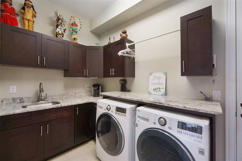 Large laundry room with sink and storage