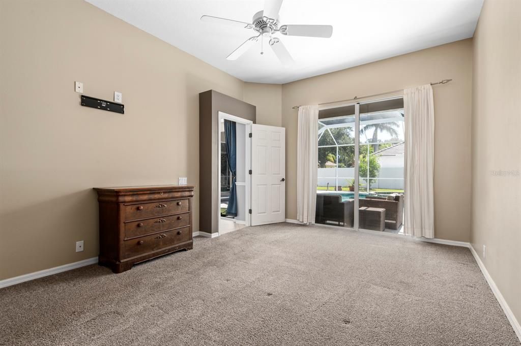 Primary Bedroom can accommodate a King Bed, Dressers, and so much more. Sliders go to the Lanai