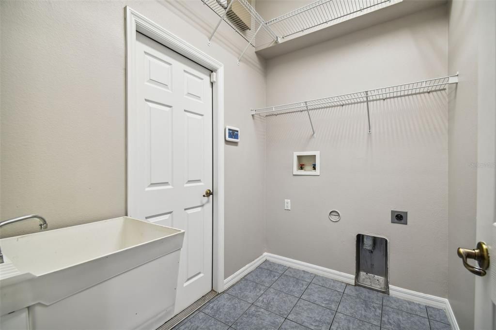 Spacious Laundry Room With Sink and Lots of Shelving!