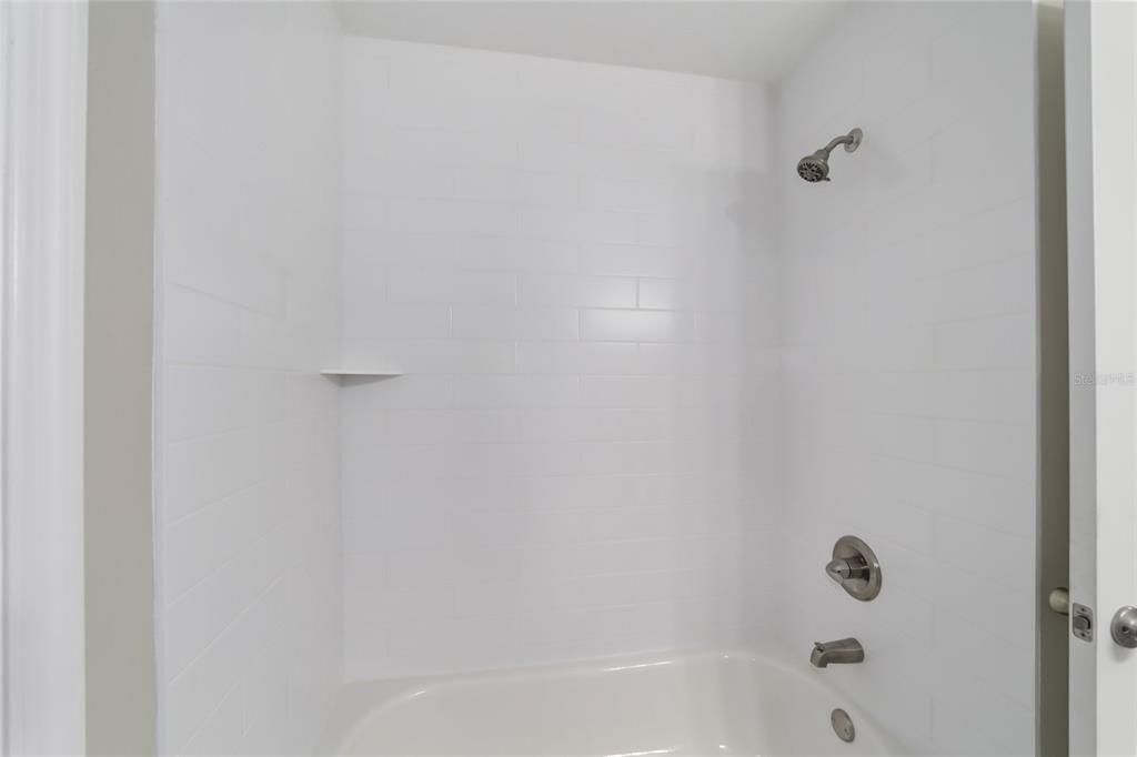 Guest bath tiled tub shower combo