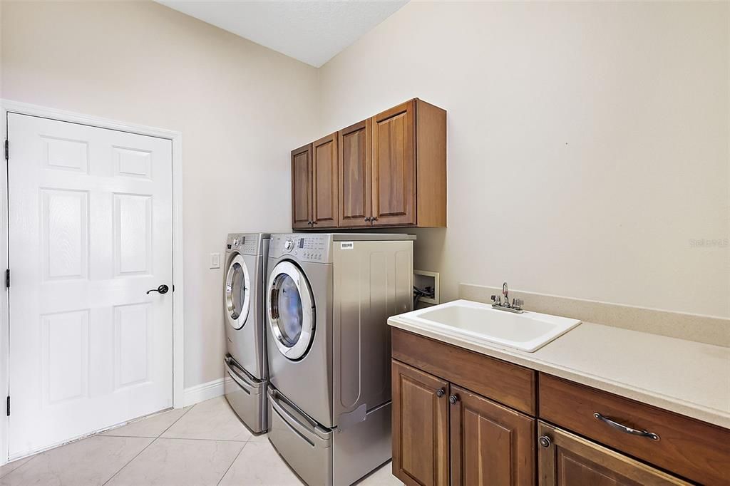 Inside laundry room w/utility sink & extra cabinets