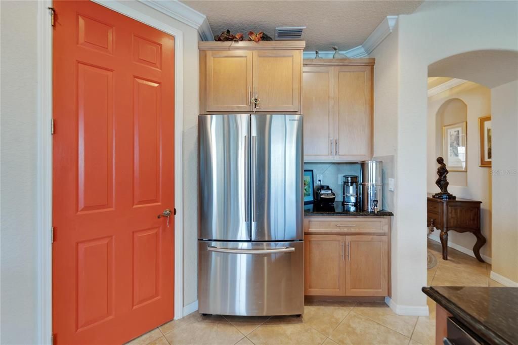 Bright, open and spacious...notice the detailed well crafted quality wood cabinetry with handles in this sparkling clean kitchen and high end appliances.