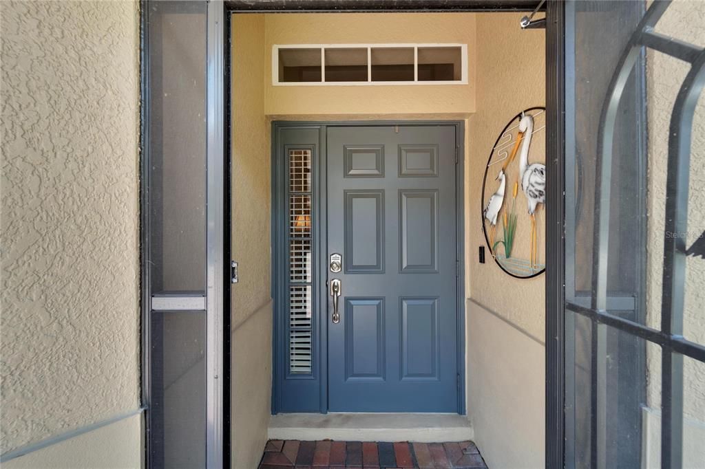 As you enter the screened in front entryway and you will notice the overhead window and side lights that emphasize natural light, on those warm sunshiny Florida days.