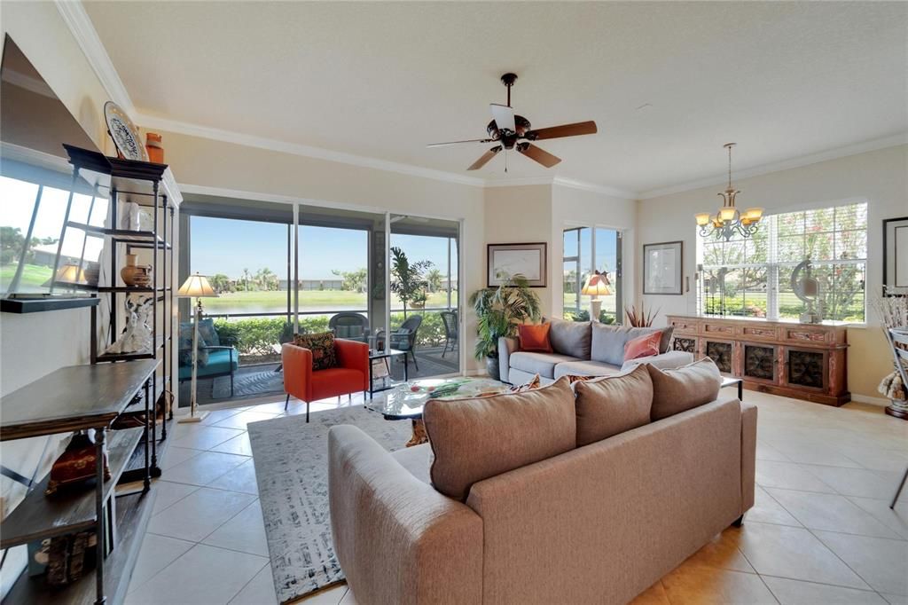 Living room is open and spacious with lovely contemporary tile flooriing and ceiling fan.
