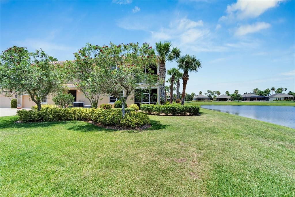 Lush landscaping and a pond view offers privacy to the rear of the downstairs unit villa.