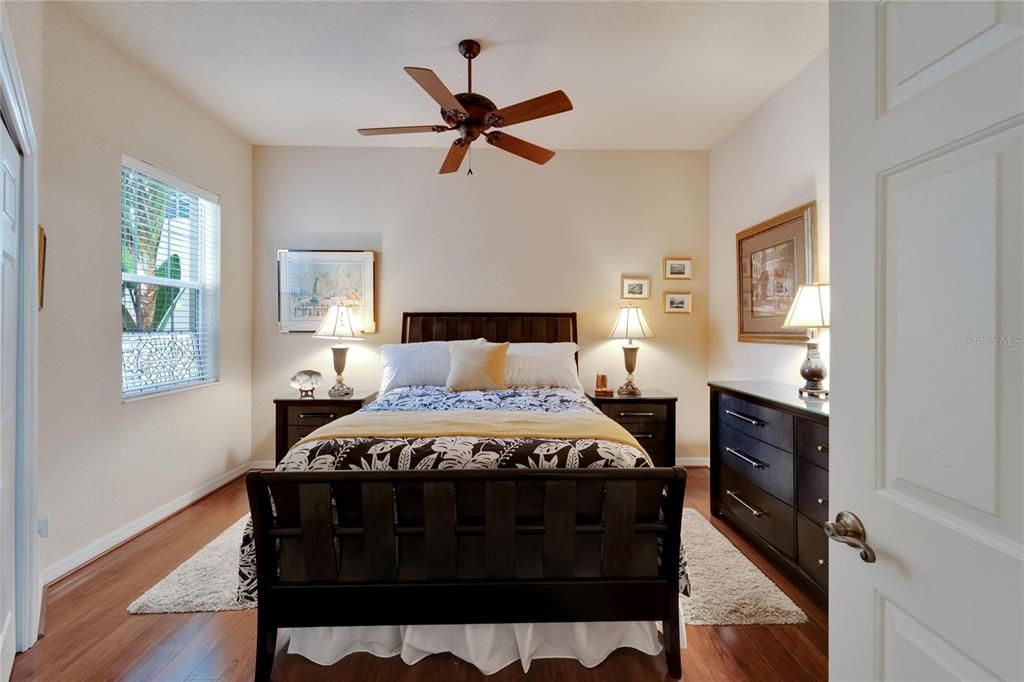 Bedroom #2 is a nice size with ceiling fan, wood floors, and spacious corner closet for guests and visitors.