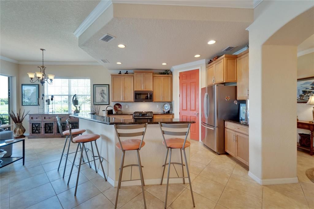 View from the kitchen into the dinette area and living room which overlooks a sparkling pond water view. This spacious clean living area has multiple sliding doors perfect for opening up when you are ready for the sea breezes to flow through the home.