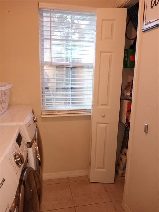 Laundry room with closet