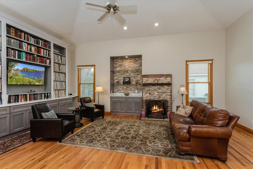 Large Family Room with fireplace -can use gas burning or wood burning - with stacked stone background. 11' custom built entertainment wall with ample storage below. Custom built-in display area with glass shelving and storage below.