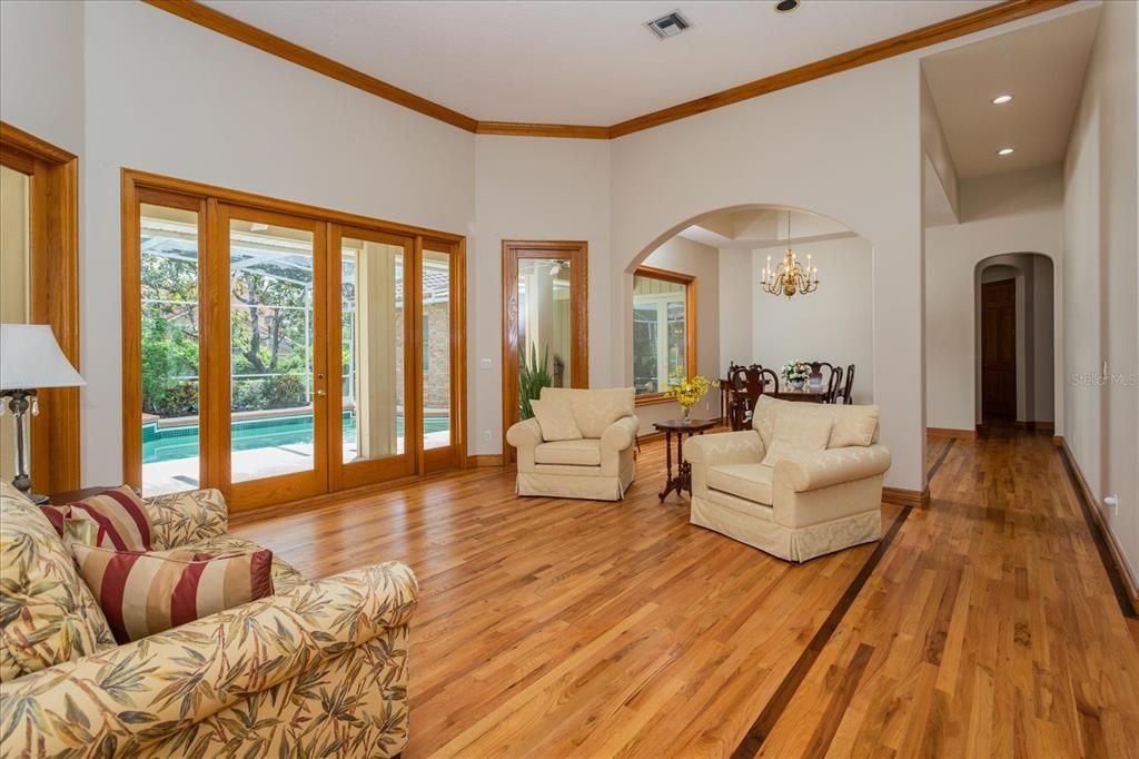 OPen Plan - Living opens to formal Dining Room which has a large picture window overlooking tropical pool setting.