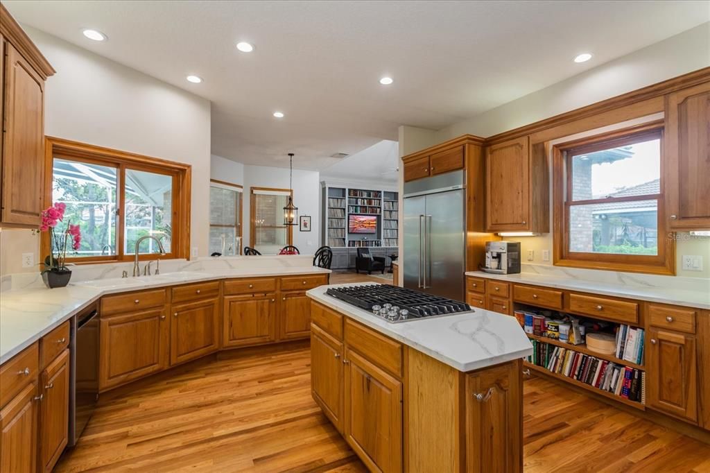 The Kitchen with quarts counters, shelves for your cookbooks, walk-in pantry all new  Kitchenaid appliances.  Gas cooking.   Pass-thru sliding window over sink opens to outdoor Kitchen. Abundance of storage!