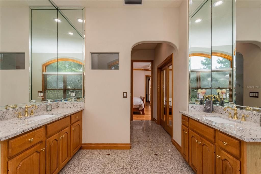 Master Bathroom boasts granite counters, dual vanities,brass plumbing fixtures, marble floor, jetted tub, new walk-in large shower with seat. Beyond the bathroom doors open to a very large walk-in closet  with built-in dresser.