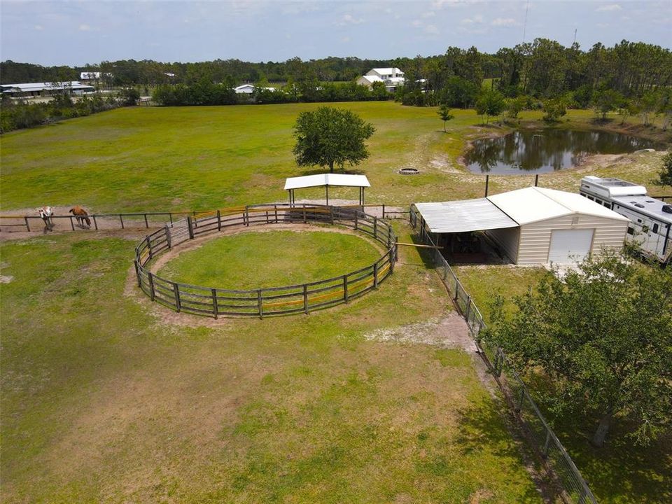 Round pen, tractor port and 20x20 shed.