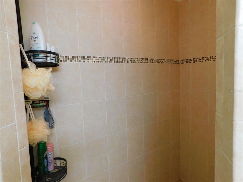 Shower has corner hook for your soaps and shampoo, etc.