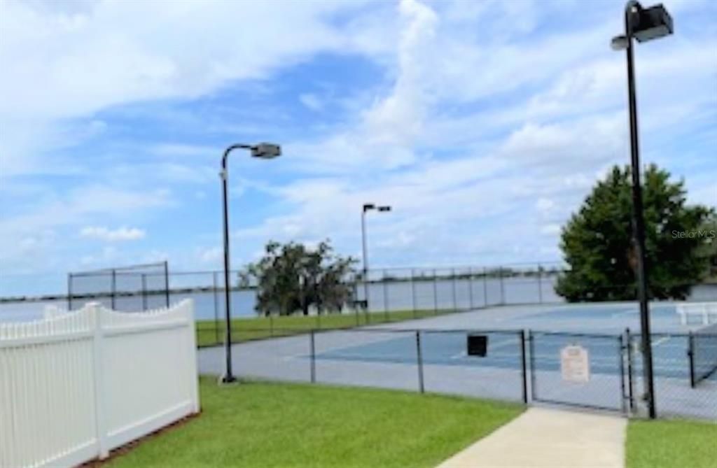 Tennis court with lake view.