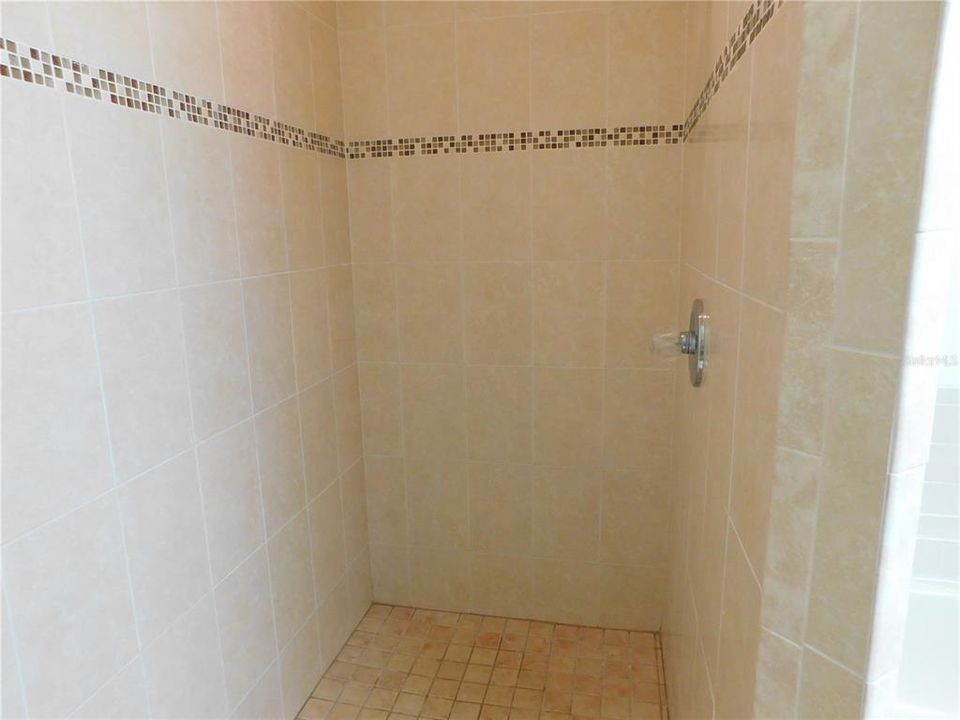 Bath walk-in Shower all tiled and tri shower head.