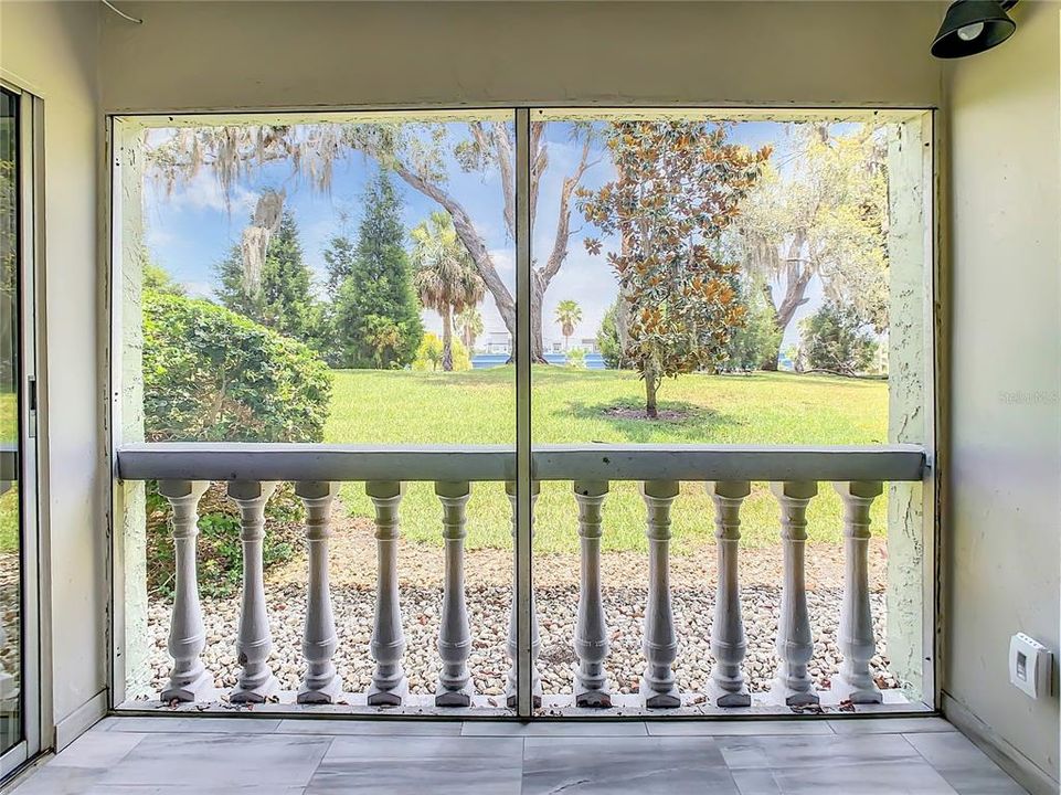 screened-in lanai adorned with complementary tile flooring. Savor a cup of coffee on breezy mornings or relax on tranquil afternoons or evenings as you unwind while relishing the picturesque views of the meticulously maintained grounds