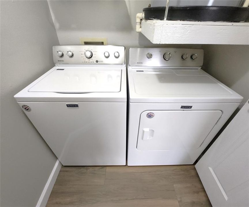 Interior laundry room includes Maytag washer and dryer