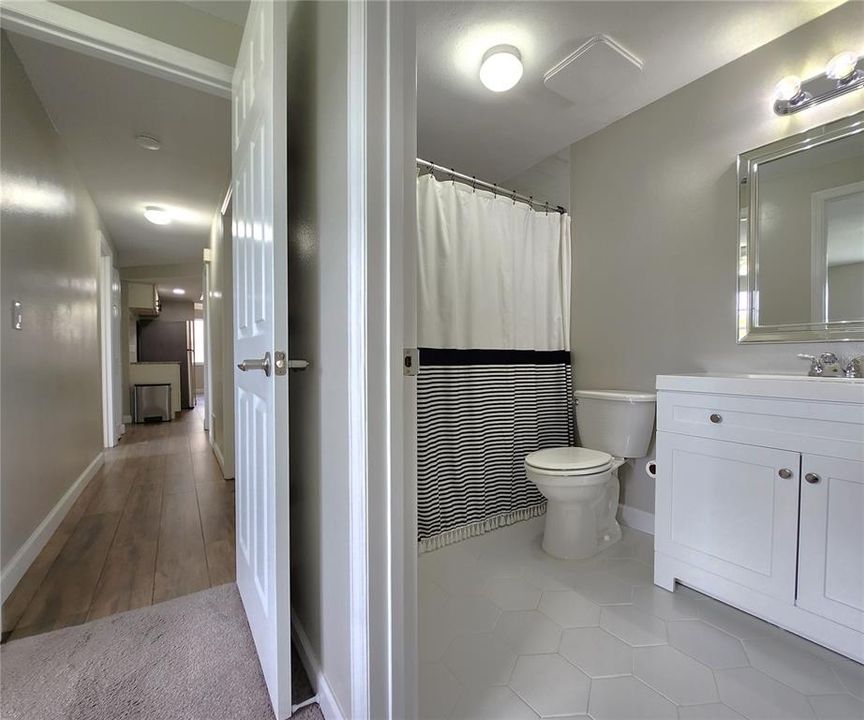 Master bathroom and view of hallway