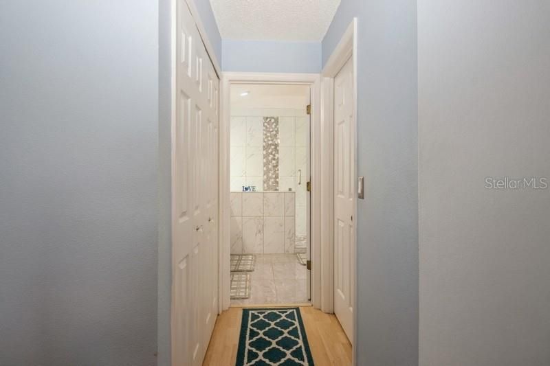 hallway with closets to primary bath