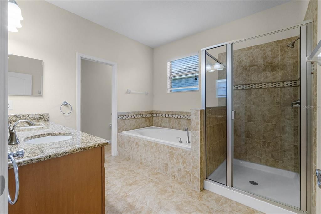 MASTER BATHROOM: Glass Enclosed Shower, Garden Tub, Enclosed Toilet