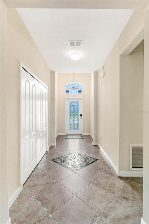 FOYER/VIEW TO FRONT ENTRY:Ceramic Inlaid Medallion w/Ceramic Tile Flooring, Large Linen Closet