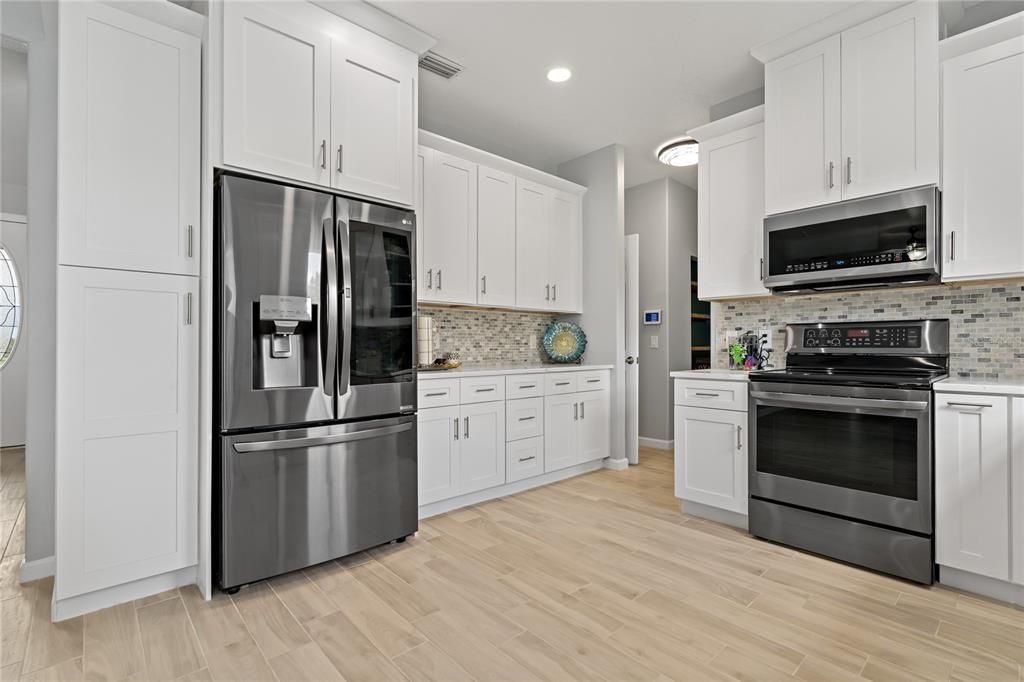 Beautifully remodeled Kitchen with Stainless Steel appliances, new 42 inch upper cabinets and Granite counter tops