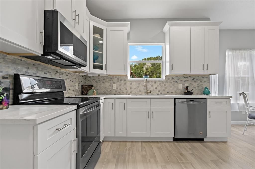 Beautifully remodeled Kitchen with Stainless Steel appliances, new 42 inch upper cabinets and Granite counter tops