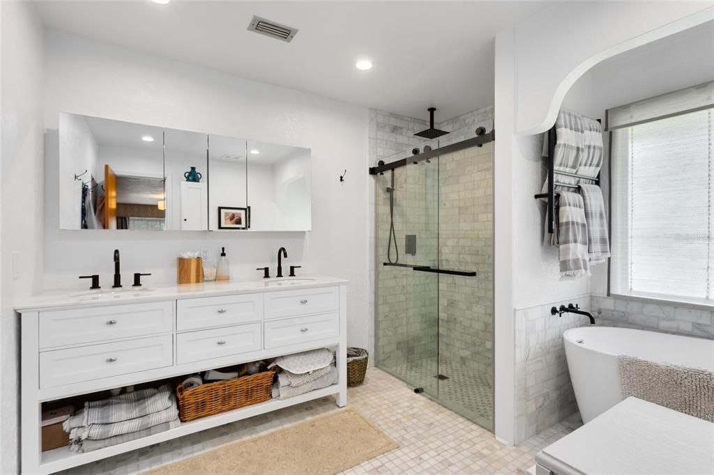 Your spa-like en suite master bath boasts a dual vanity, walk-in shower with a rainfall showerhead, and a separate soaking tub, inviting you to indulge in relaxation.