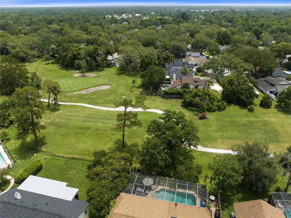 Aerial view from above the home out to the 5th tee of the golf course.