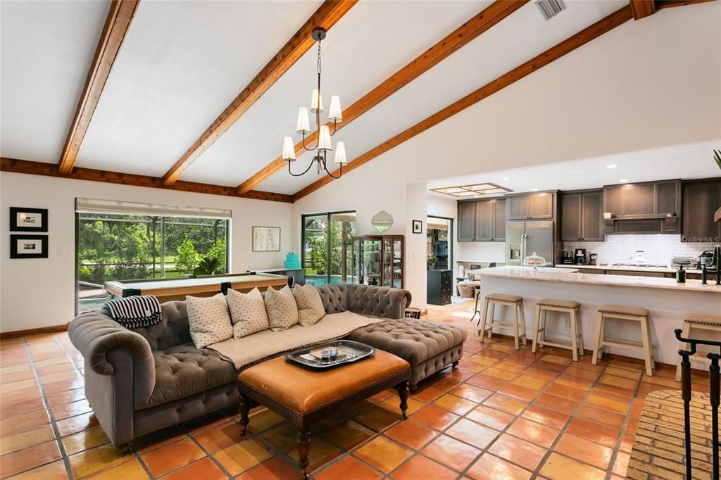 The vaulted ceilings and exposed beams flow into the family room and dining areas.