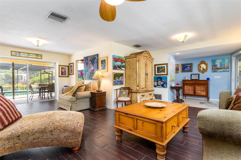 This view in the Living Room shows the large Foyer to the Right and also to the left, the access directly to the Lanai via Sliding Glass doors.