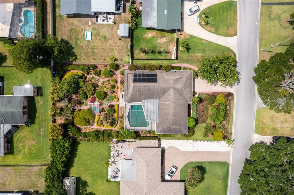 This aerial view shows the AMAZING winding path thru the garden in the back yard.  A new roof is being installed and the Solar panels for pool heat will be removed.