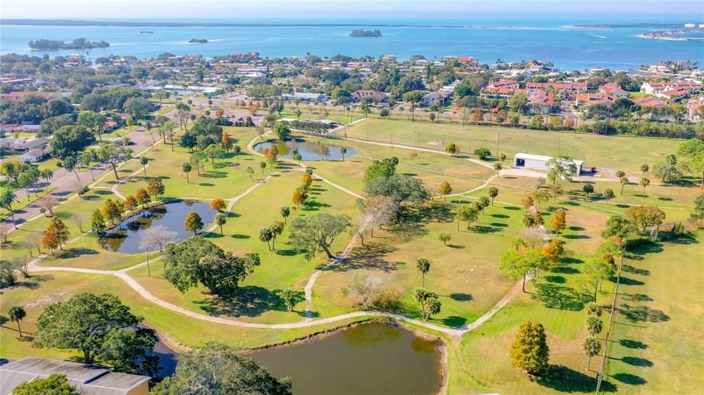 This aerial features Stirling Park and is looking West at the Intracoastal Waterway.    Stirling park has walking paths/trails and a Driving Range to work on you skills before heading to the Dunedin Golf Club!