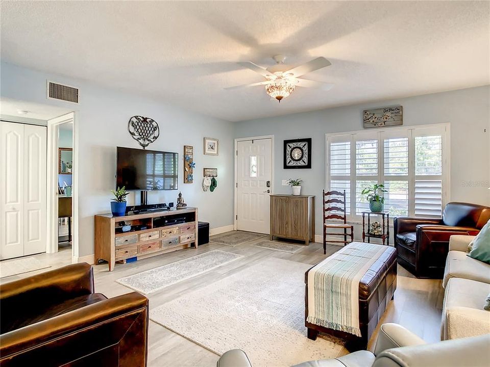 new open living space with luxury vinyl flooring flowing seamlessly throughout, neutral colors with white accents, fantastic floor plan, and a back door out to your fully fenced patio with new awning