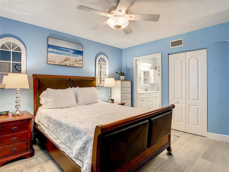The master bedroom retreat is also a nice size and offers a large walk-in closet and an en-suite bath with a new dual sink vanity and a well-appointed stand-up shower. The hall bathroom has been updated with a similar vanity and new flooring