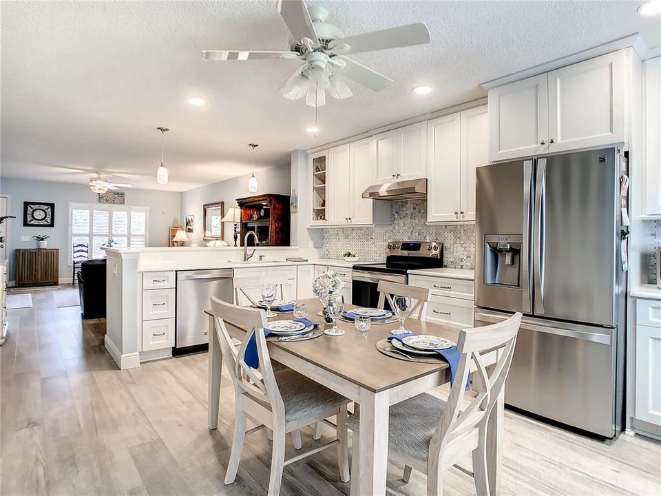 The Kitchen upgrades including 42” soft close white cabinets and striking quartz countertops with a raised breakfast bar. The stainless-steel appliances include Kenmore Elite convection oven, hood, refrigerator, dishwasher, and a wine refrigerator