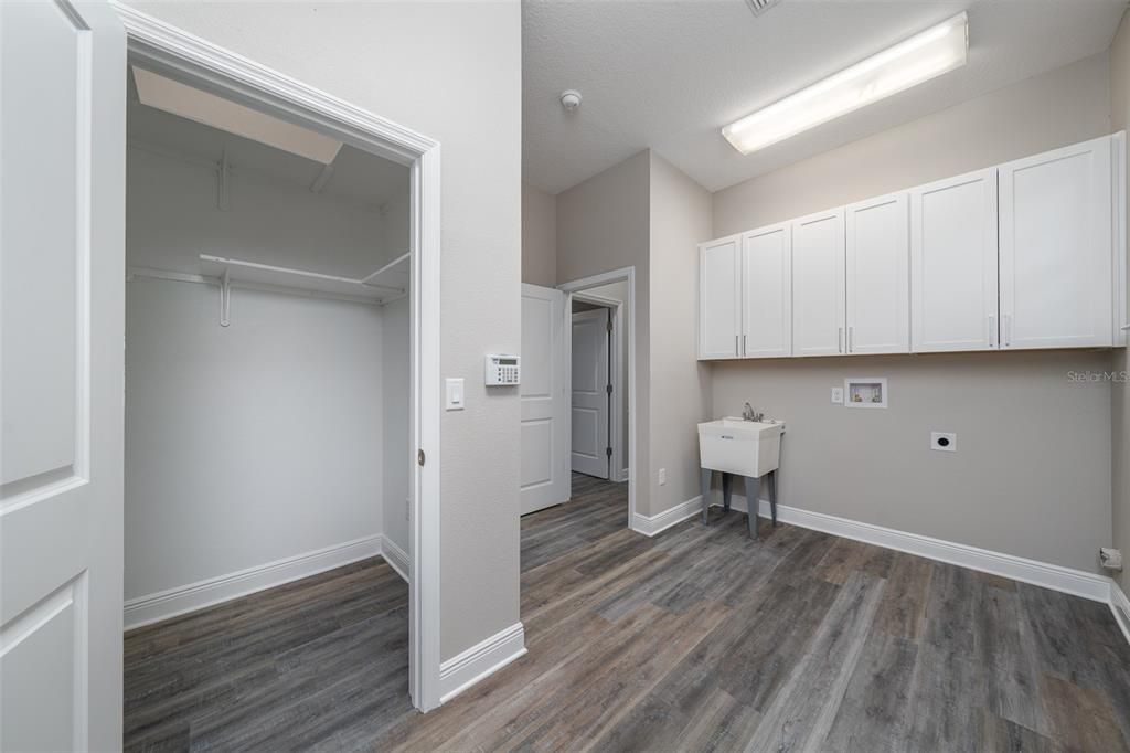 The laundry room of your dreams!  So much storage - cabinets and another walk in closet!