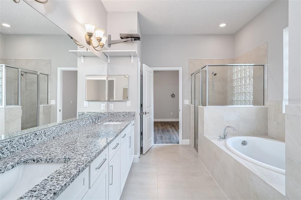 Come relax in the primary suite bath!  It opens to another bedroom - perfect for a gym, office, or nursery.  It could also easily be closed off for more privacy.