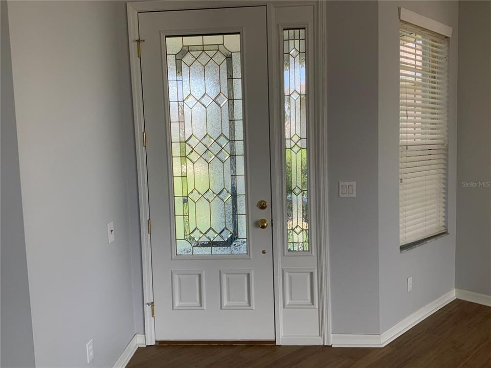 Front entry with lovely leaded glass door.  Front porch is screened. Great for cross breezes and to keep little bugs out!!