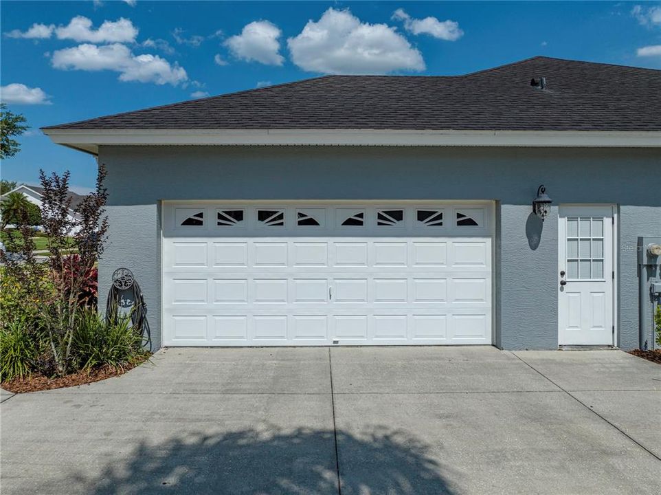 Double car garage with side entry door.